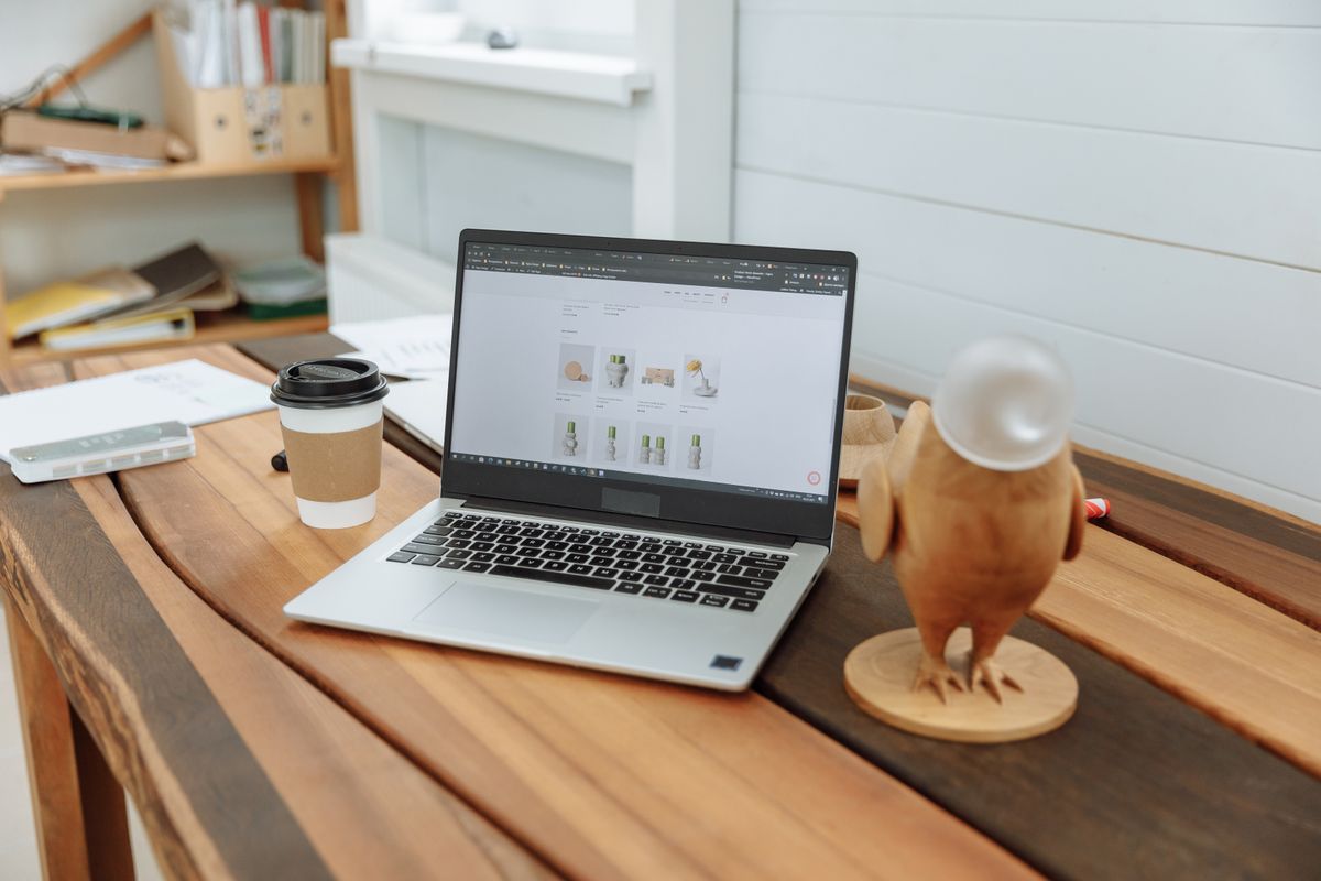 Laptop on a desk showing a website design